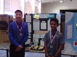 Rohan Bhushan and Christopher How stand before their winning project.  (Photo: C. Reeb)